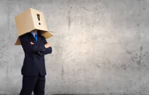 A business man with a cardboard box over his head, as a metaphor for his determining CMMC is not applicable.