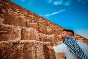 Image of a man climbing a pyramid as a metaphor for transitioning from CMMC Level 1 to Level 2